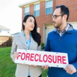 man and woman front of house How to stay in my home after foreclosure