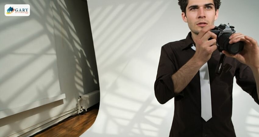 man with camera standing in room
