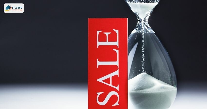 hourglass next to a sign reading "sale"