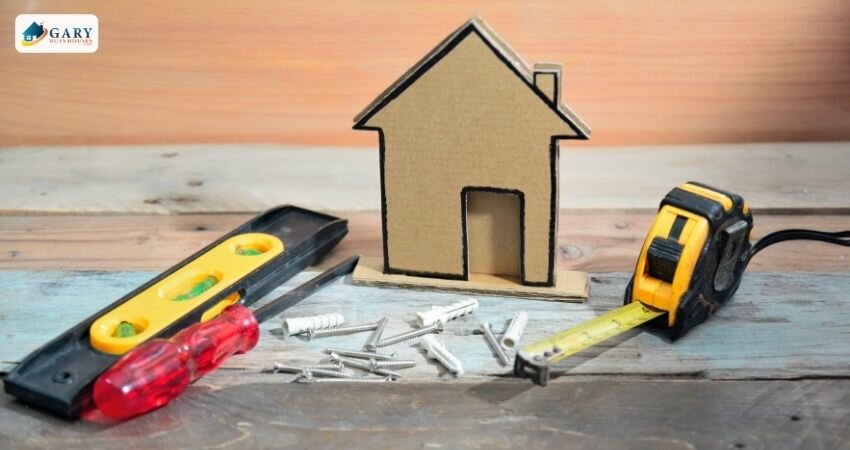 tools next to a house cut out of cardboard