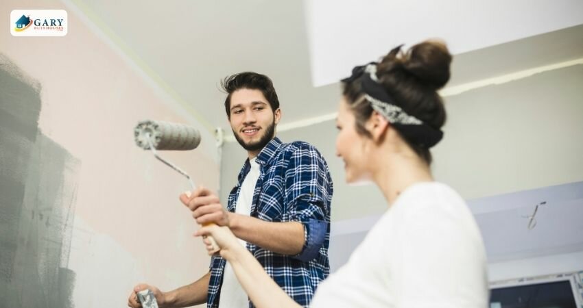man and woman painting wall