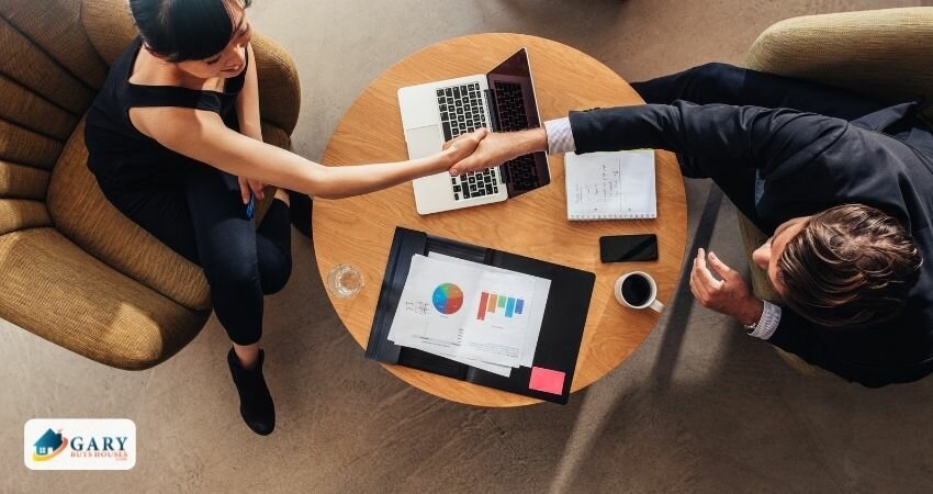 A house owner and buyer shake hands over a deal or an agreement.