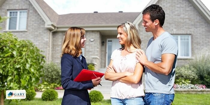 Home-owner and house buyer having a discussion in regards to selling rental property