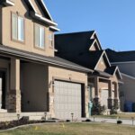 A brown stucco two story house.