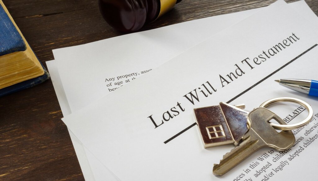 Last will and testament papers and key as symbol of property.