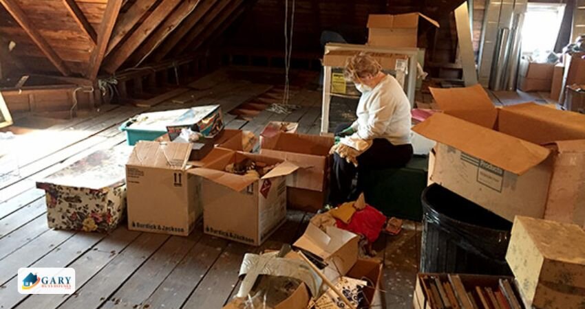 Woman cleaning up the attic