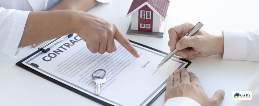 Someone signing a contract to buy a house