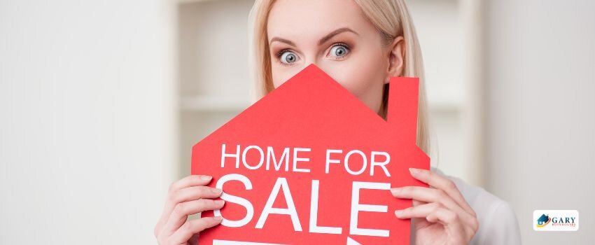 Girl holding up a sign that says "House for sale"