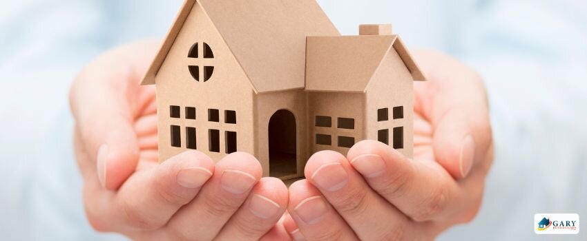 Someone holding a mini house