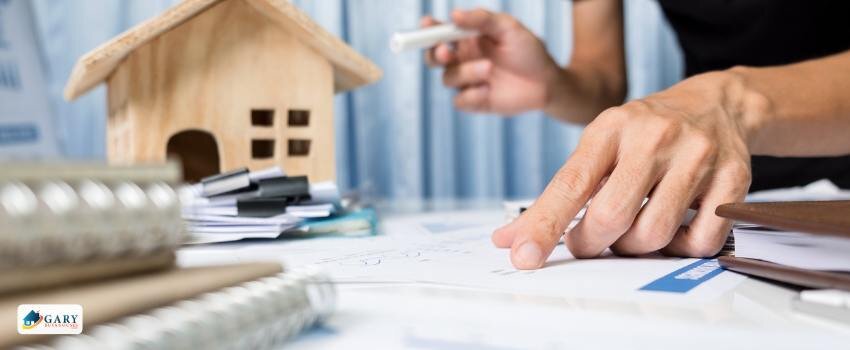 man hand going over a quitclaim deed on a table or desk