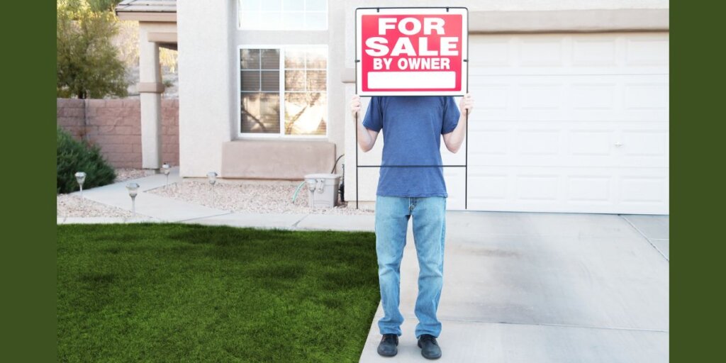 Man holding a for sale 
 by owner sign above his head.