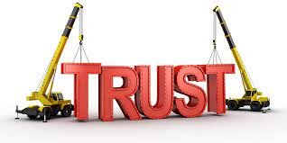 image of 2 cranes holding up the word "trust"