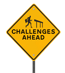 picture of a sign with the words challenges ahead