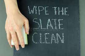 chalkboard with "wipe the slate clean" on it and a hand about to wipe the board clean.