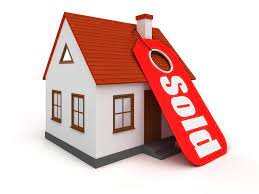 picture of a house with a sold tag on it