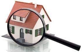 home with a magnifying glass on it representing a home inspection.