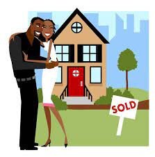 A couple in front of their house with a "sold" sign in front signifying that have sold their house.
