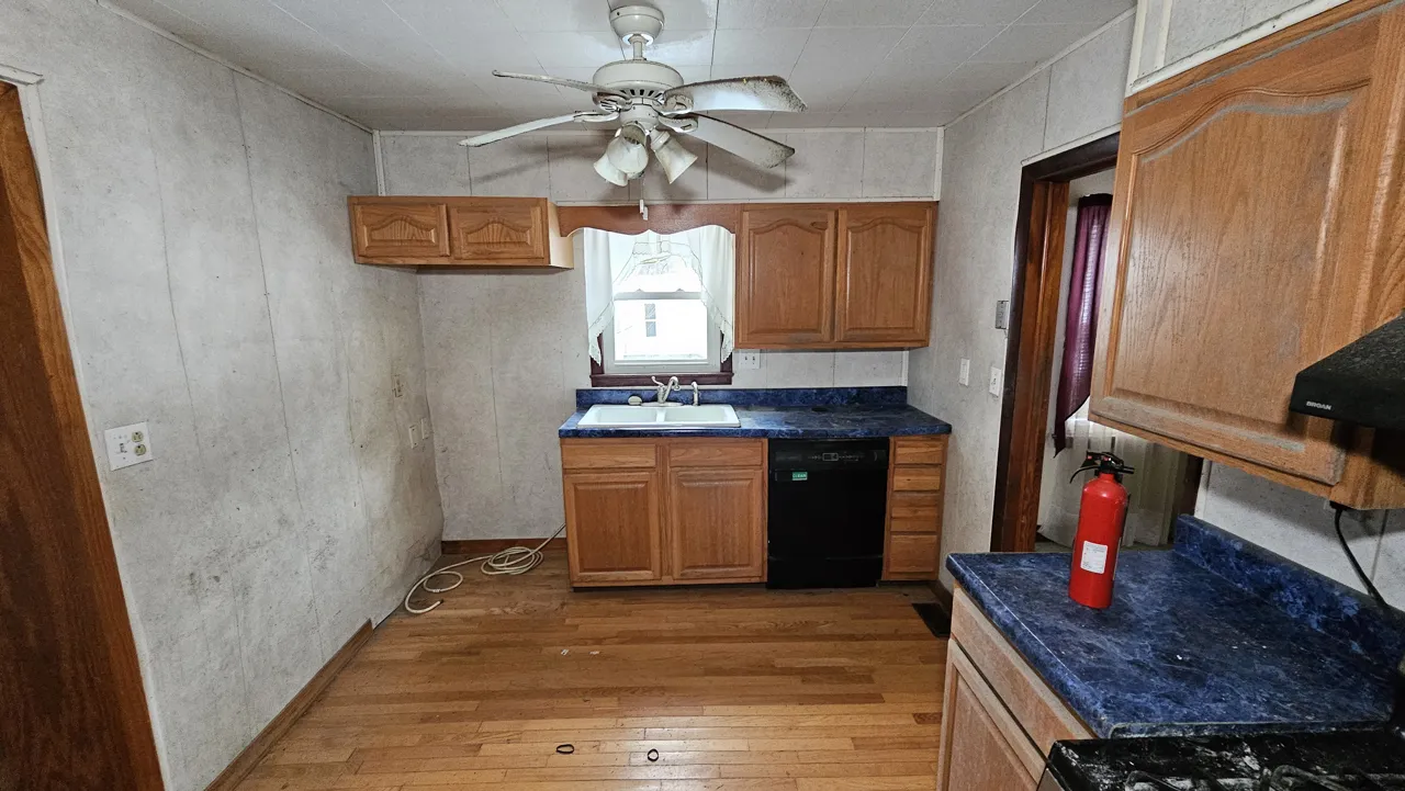 Georges Creek kitchen in January 2024 with wood cabinets, blue counters and a ceiling fan