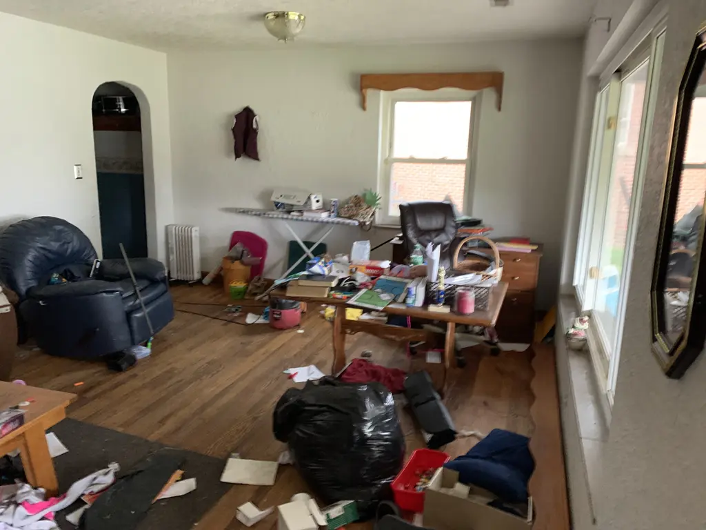 Living room at the Hallison Circle house in Milton before renovation, with furniture and belongings