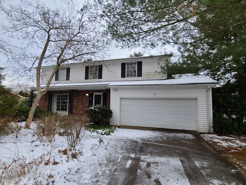 Front exterior of 60 Lee Street in St. Albans, WV, before work, with snow on the lawn and driveway
