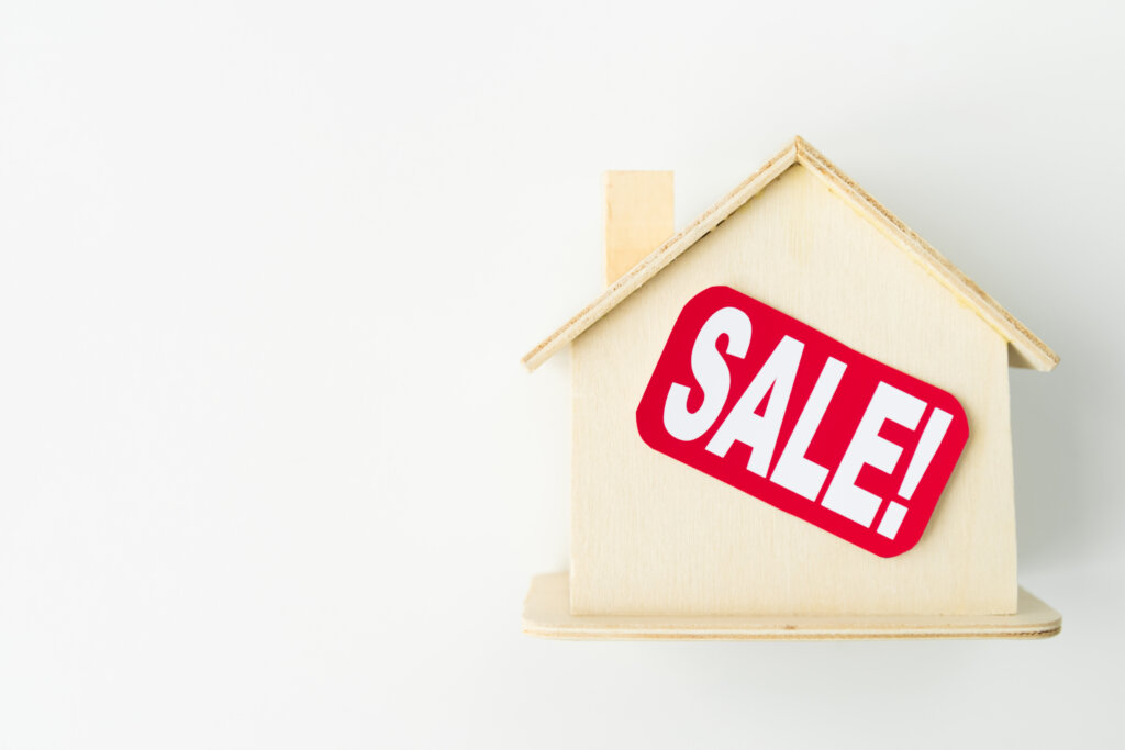 photo by freepik - Small wooden house with sale sign