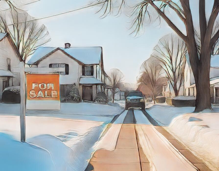 house with a for sale sign during winter season
