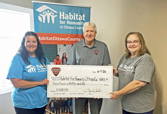 Homesmith founder/CEO Barry L. Smith (center) is pleased to present Habitat for Humanity of Ottawa County Community Engagement Director Valerie Winterfield (left) and Executive Director Debie Heiks (right) with a donation at their offices in Port Clinton, Ohio.