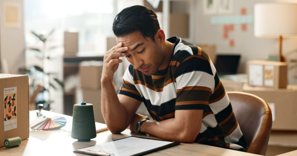 Distressed man reviewing paperwork