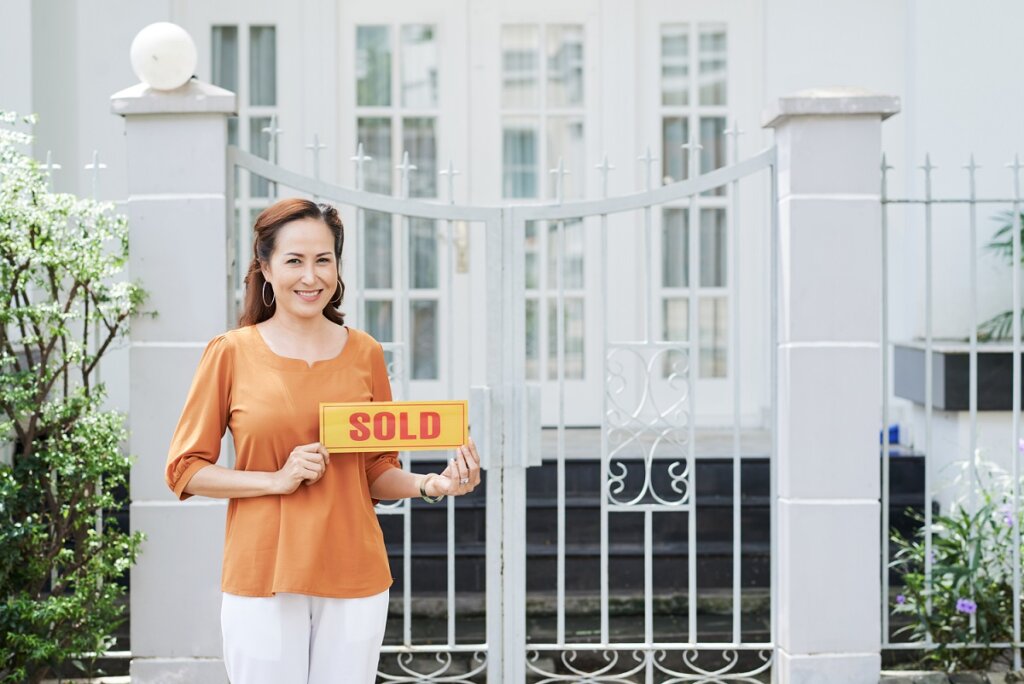 Portrait of pretty mature Asian woman sold her house