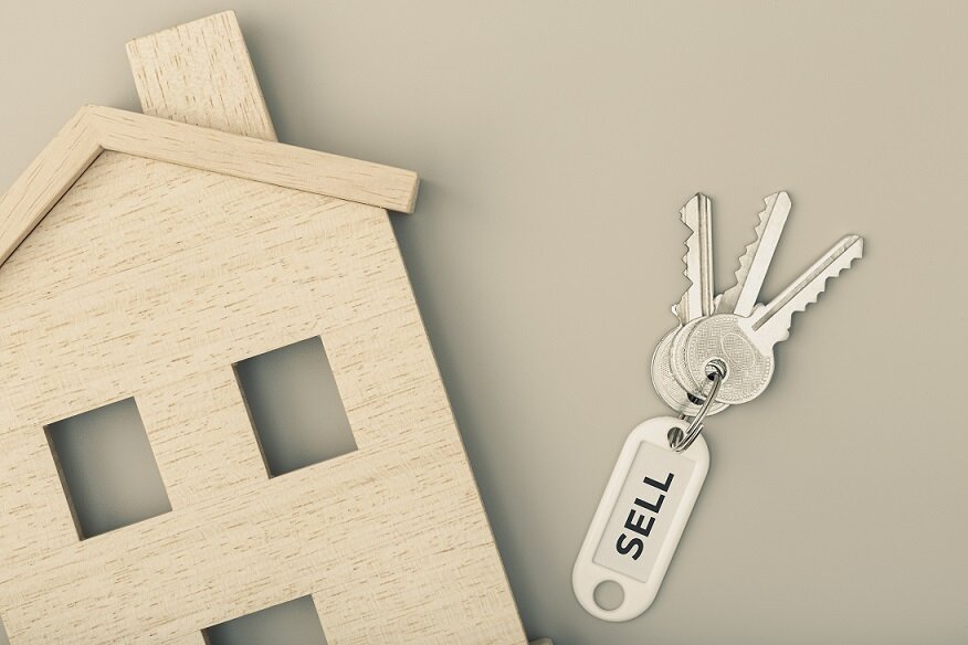 Selling a house concept. Real estate market. House icon with keys. Copy space. Top view