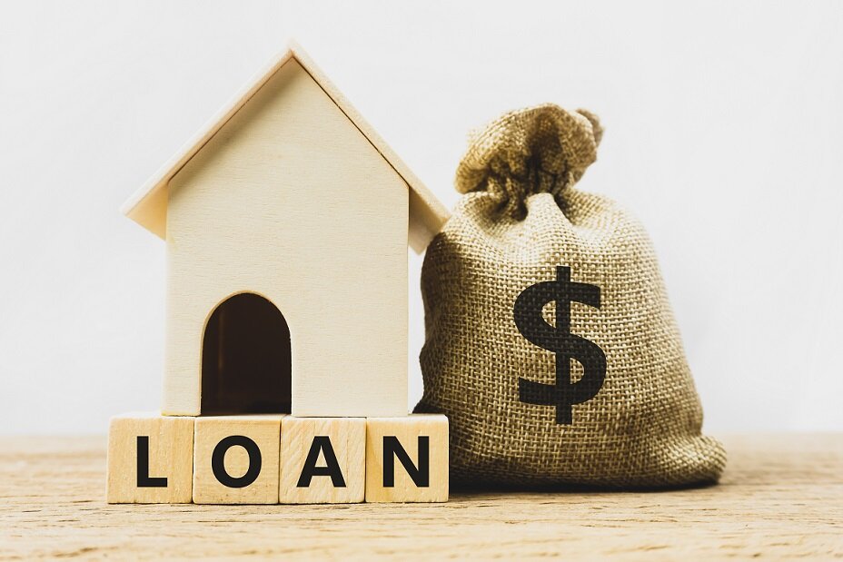 Home loan, mortgage, home insurance, financial mortgage for house concept. A dollar money in bag and residential model on a wooden block. Depicts borrow sum of money or savings for item of a property.