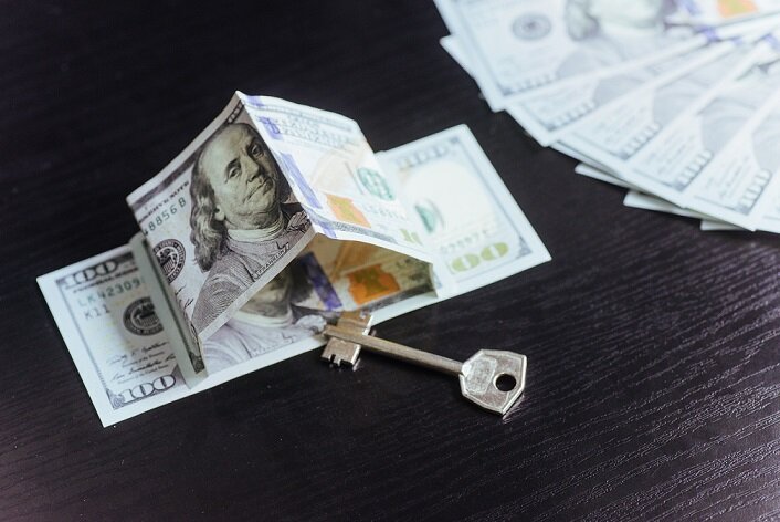Mortgage, investment, real estate and property concept. Dollar money and house keys
