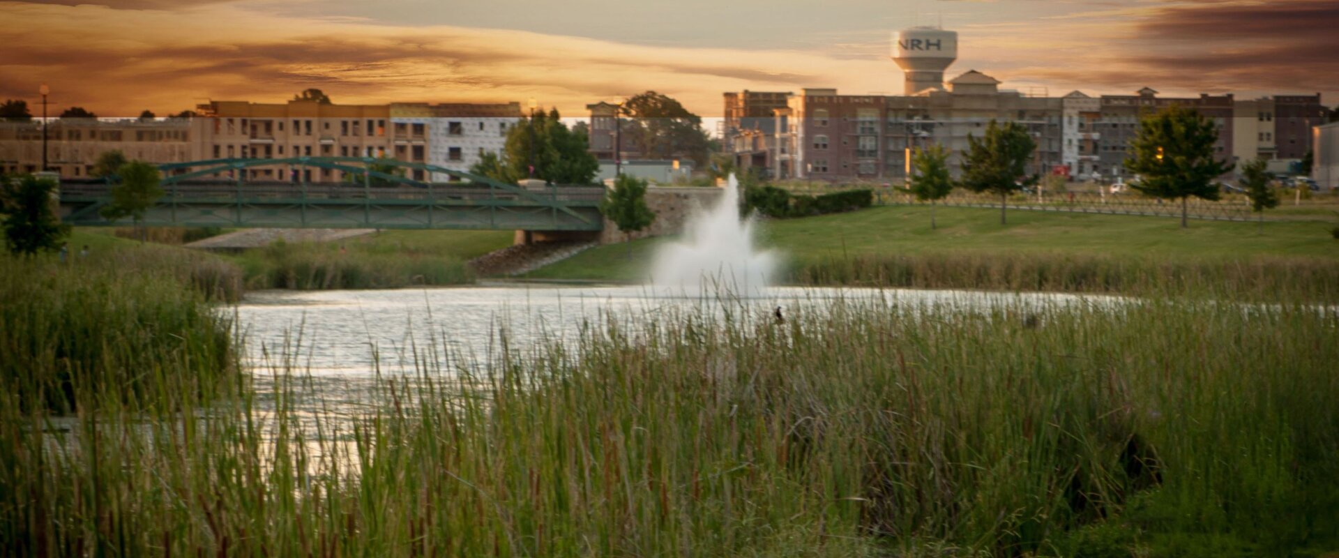 North Richland Hills photo with sunset and fountain in lake with city offices and water tower in background