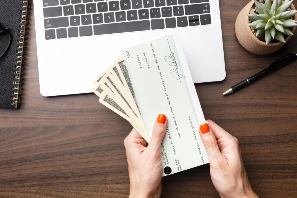 hands holding cash check