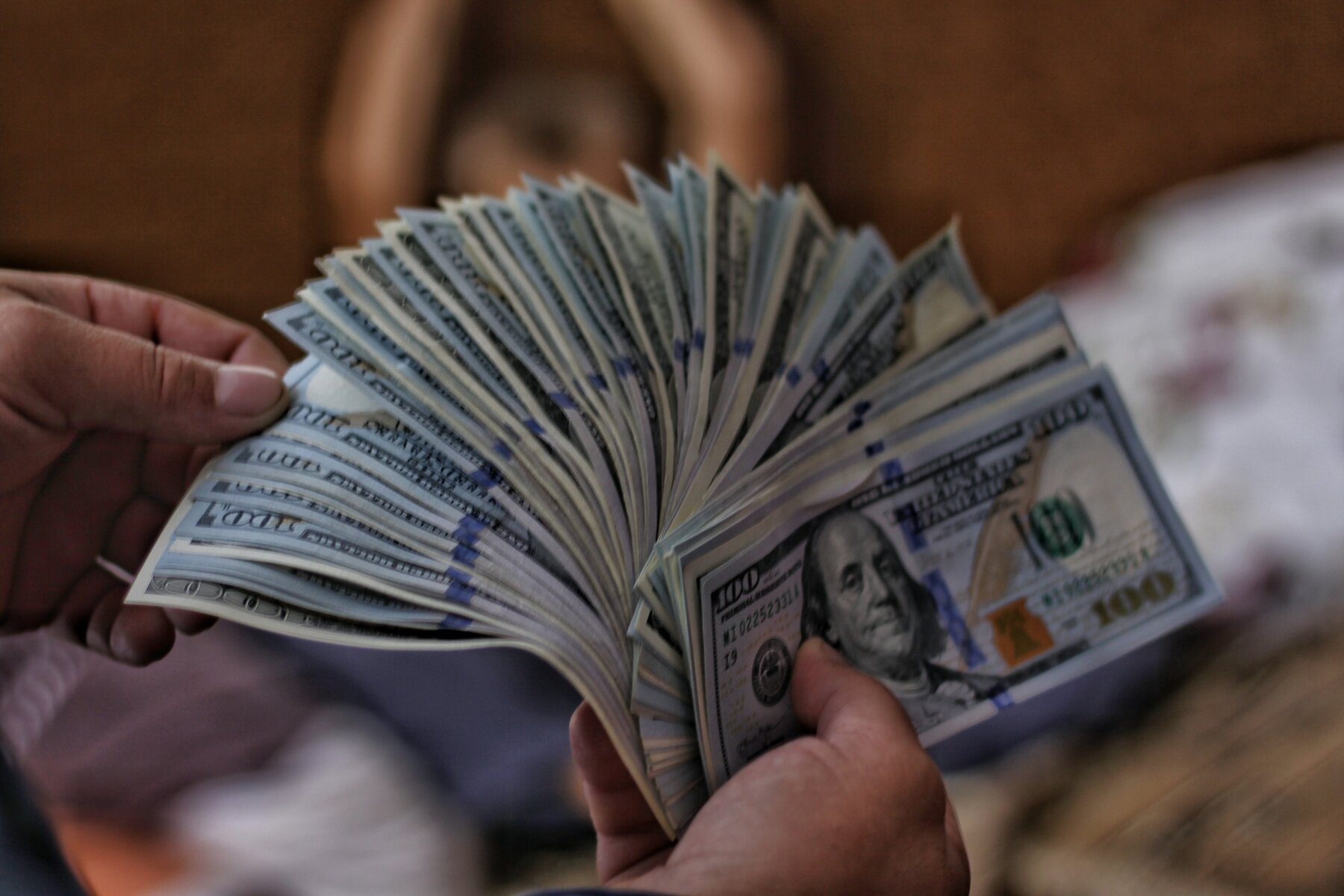 How To Make Money Buying and Selling Mortgage Notes in [market_city] or Cincinnati - person holding money