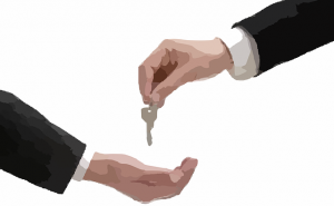 A real estate agent handing keys to a client