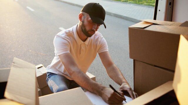 person labeling boxes
