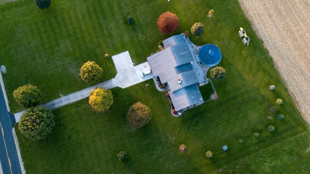 aerial view of a big house with a lawn
