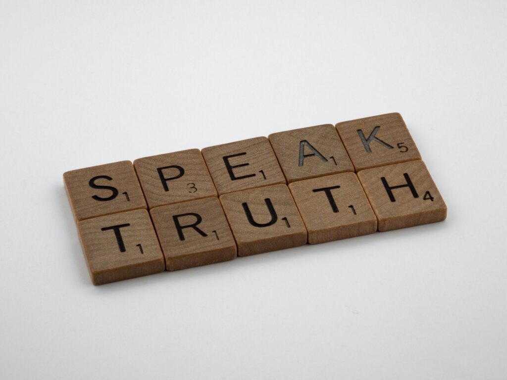 A group of letters that form: SPEAK TRUTH.