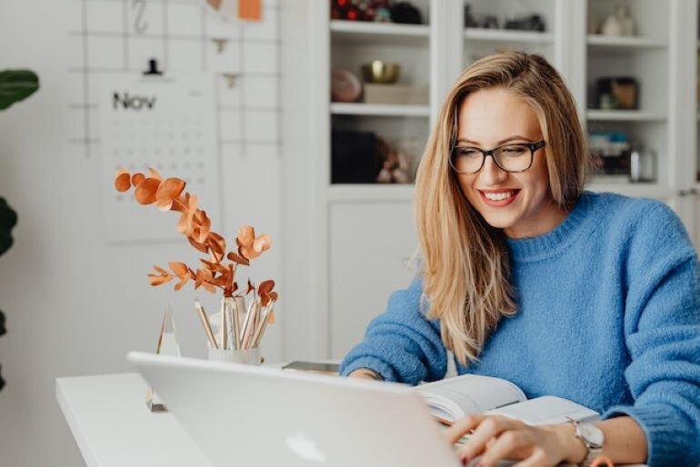 A woman is using her laptop.