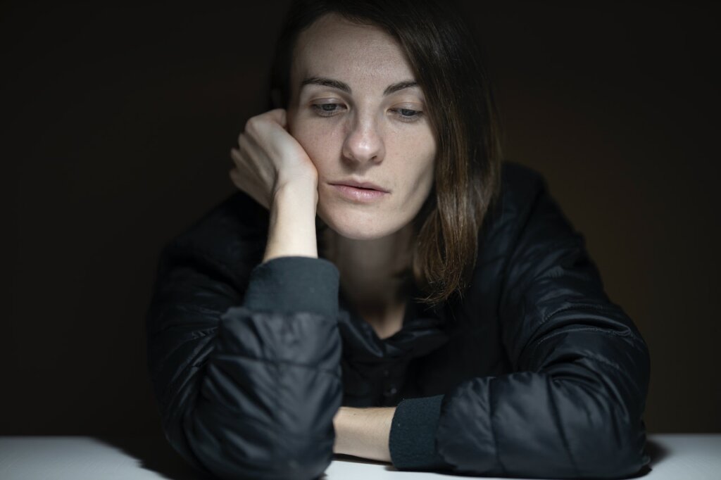 A woman feeling sad, which can be one of the side effects of selling your Johnston County NC home.