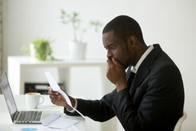A person reading a document specifying the legal issues they face due to non-compliance when completing the seller’s disclosure.