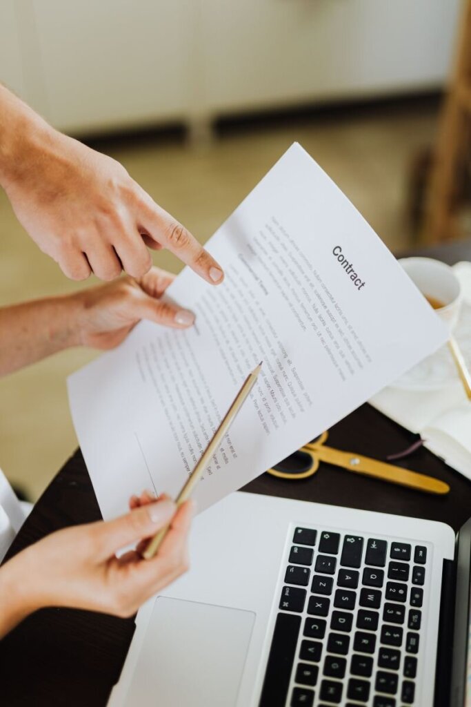 Two people reviewing documents during a California mortgage note transaction