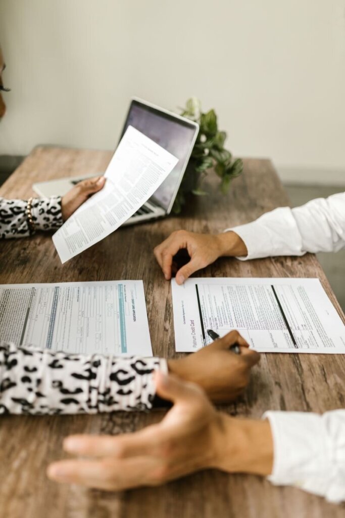 Two people reviewing documents during a North Carolina mortgage note transaction