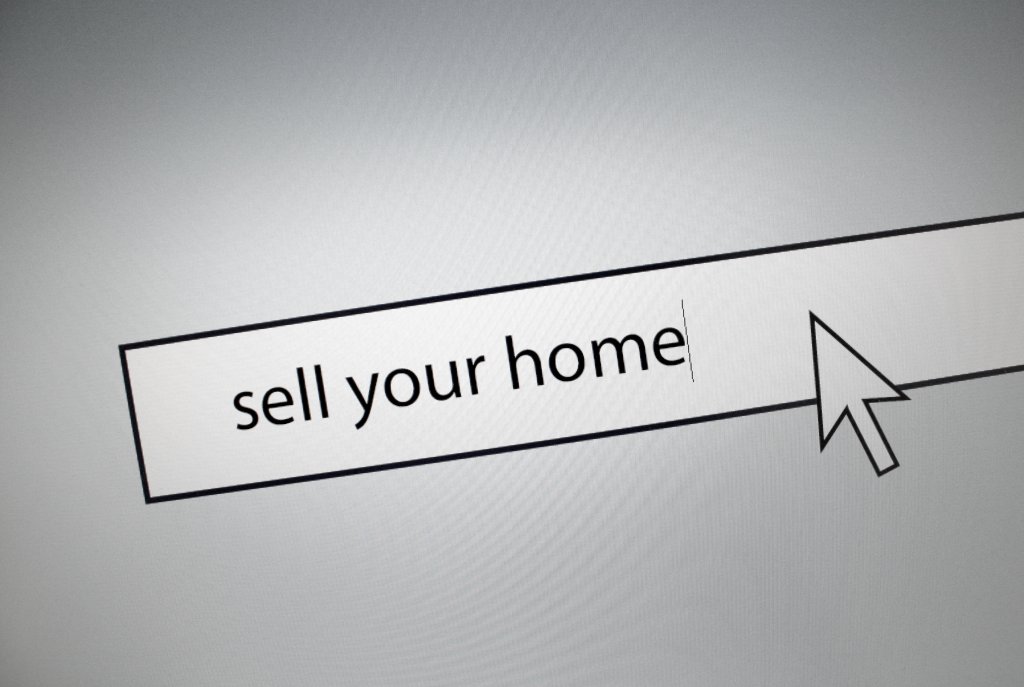 computer screen with sell you home text