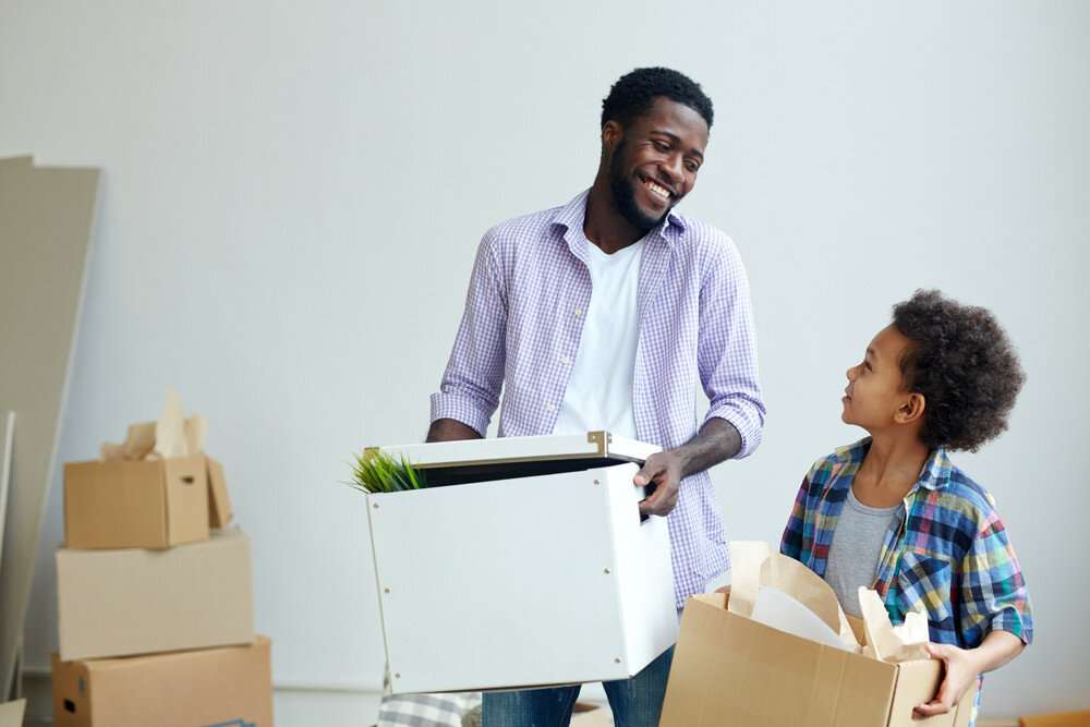 father and son moving out of house after selling it