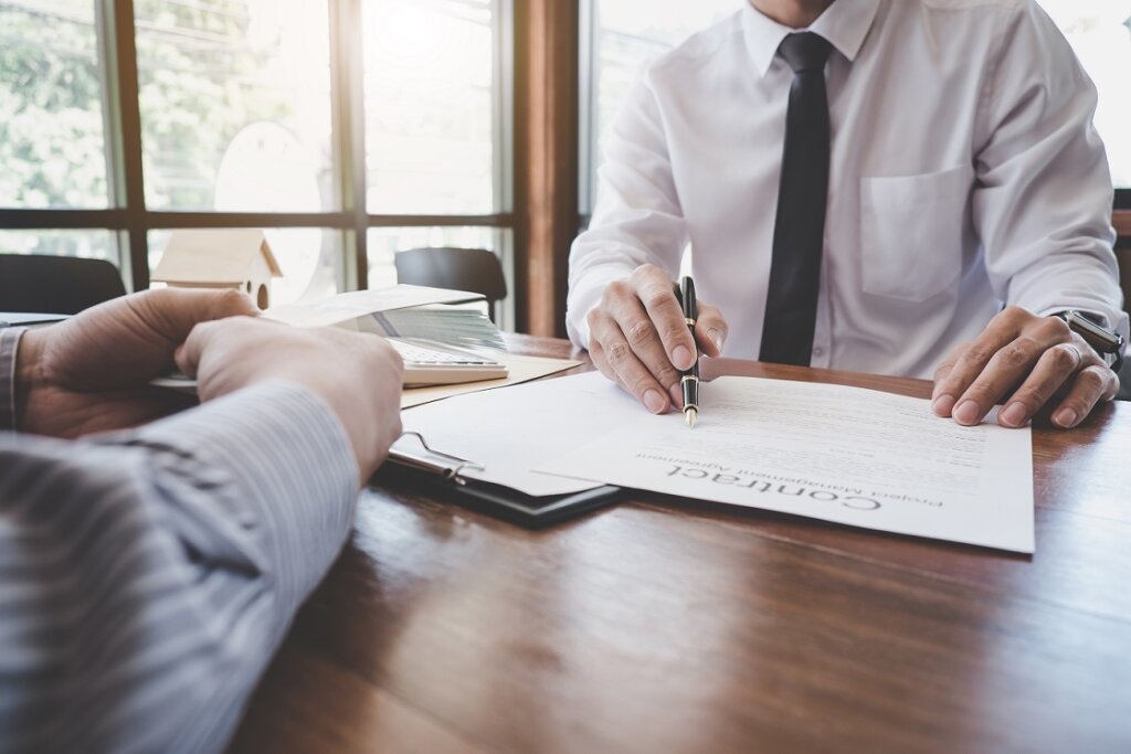 Business Signing a Contract Buy - sell house, Man sign a home insurance policy on home loans, insurance agent analyzing about home investment loan Real Estate concept.