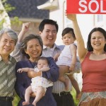 cash for houses in | asian family holding sold sign
