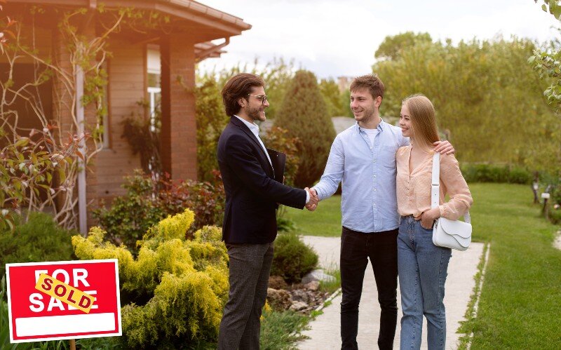 A real estate agent helps a couple list their home for sale in Milwaukee, WI