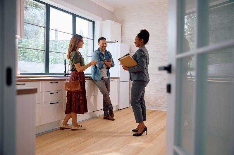 Homebuyers of NC reviewing a house before making a direct cash offer